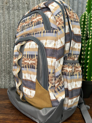 Patterned duffel bag on a wooden surface with a cactus in the background