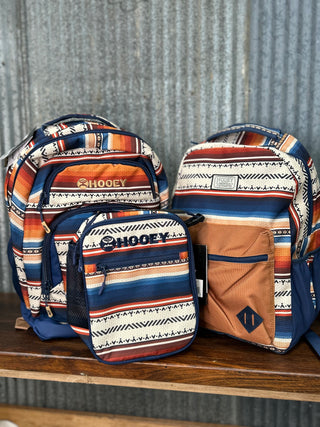 Three patterned bags with 'Hooey' branding on a wooden surface.
