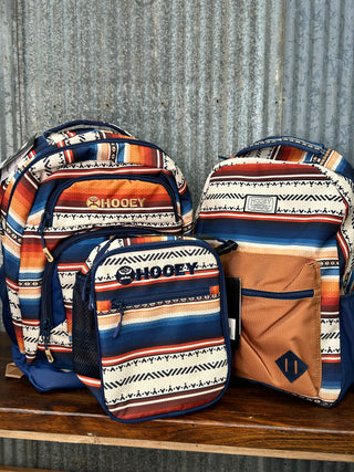 Three patterned bags on a metal surface