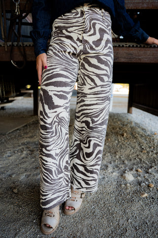 Person wearing zebra print pants in an indoor setting
