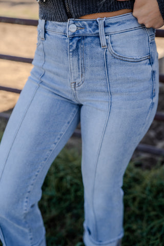 Light blue jeans worn by a person with a blurred background