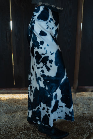 Long black and white floral dress on a dark wooden background