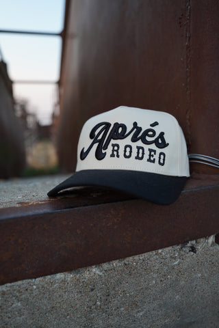 Cap with 'Napoles Rodeo' logo attached to a vehicle, blurred background