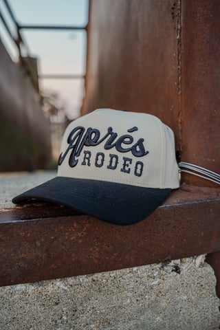 Cap with 'Apres Rodeo' text on a metal surface