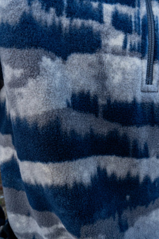 Close-up of a blue and gray patterned fabric with a zipper.