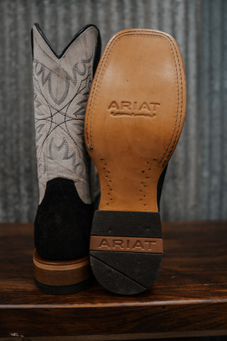 Close-up of Ariat cowboy boots with focus on sole and brand logo.