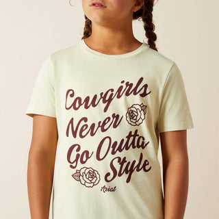 Child wearing a t-shirt with 'Cowgirls Never Go Outta Style' text and roses on a beige background