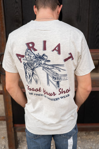 Person wearing a white t-shirt with Ariat branding and graphic on the back.