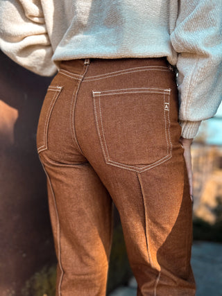 Brown pants worn by a person with a blurred background