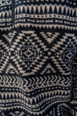 Close-up of a sweater with a black and white geometric pattern