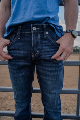 Person wearing blue jeans and a blue shirt with a blurred background