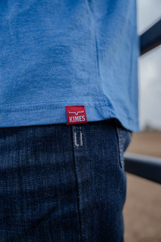 Blue shirt with a red Kimes label on a blurred background