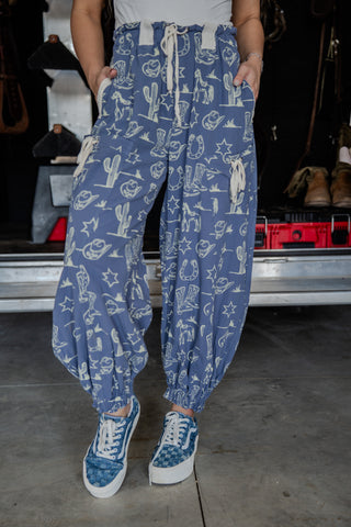 Person wearing blue pants with white patterns in a garage setting