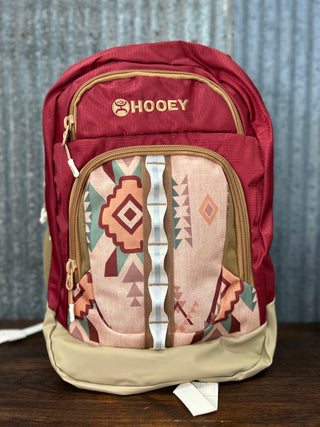 Red backpack with geometric pattern on a wooden surface
