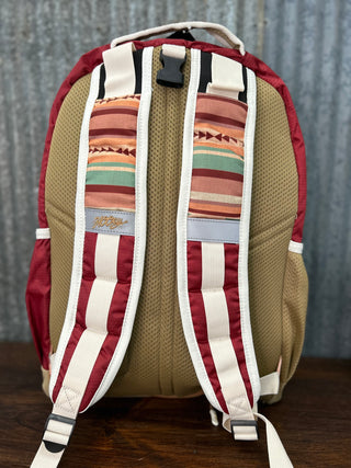 Backpack with striped pattern on a wooden surface and gray background