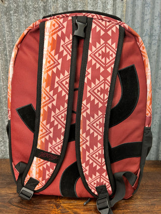 Red patterned bag with black straps on a wooden surface