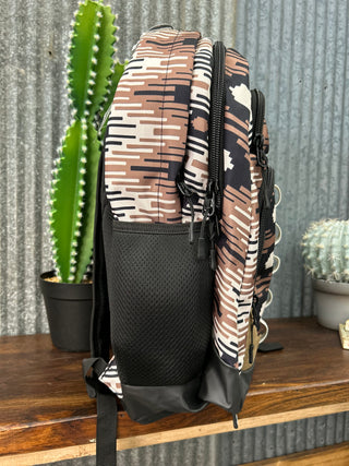 Patterned bag on a textured surface with a cactus plant in the foreground