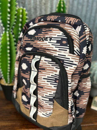 Camouflage-patterned backpack with 'HOOey' branding in front of a cactus plant.