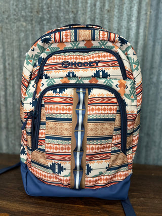 Backpack with tribal pattern and blue accents on a wooden surface