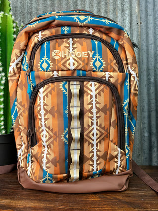 Patterned bag with visible brand logo on a wooden surface