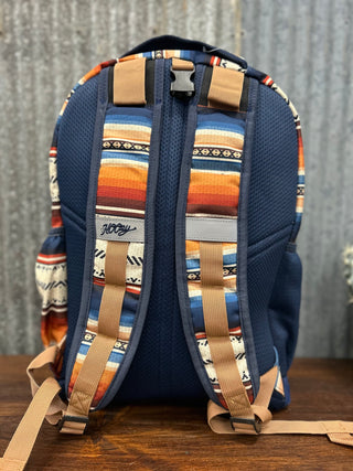Backpack with colorful patterned straps on a wooden surface