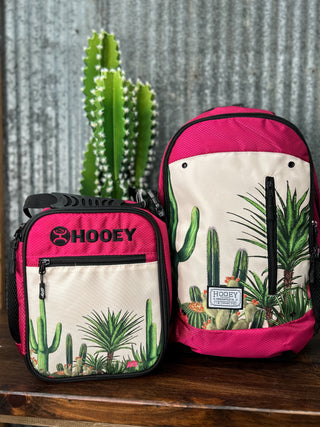 Two bags with cactus design and 'Hooey' branding on a wooden surface.