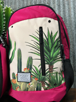 Backpack with cactus and palm leaf pattern on a textured surface