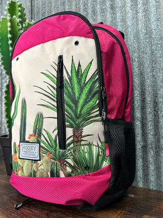 Pink bag with a tropical leaf design on a metal surface
