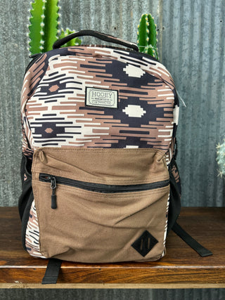 Patterned bag with a visible brand logo against a rustic background