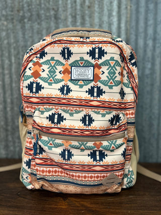 Backpack with tribal pattern on a wooden surface and gray background