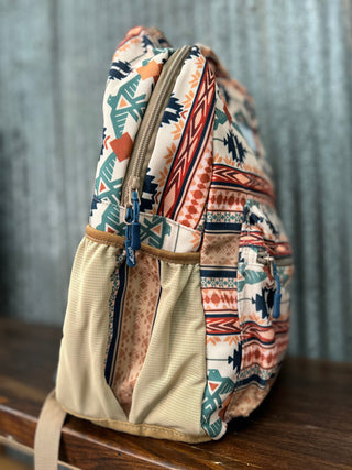 Multicolored patterned backpack on a wooden surface with a metallic background
