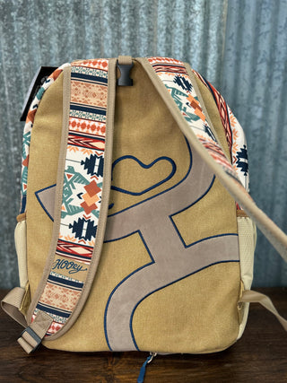 Backpack with geometric pattern and heart design on a wooden surface
