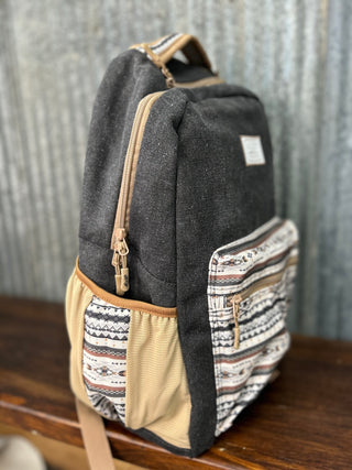 Backpack with patterned side pocket on a wooden surface