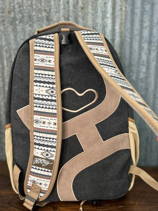 Backpack with patterned strap on a wooden surface