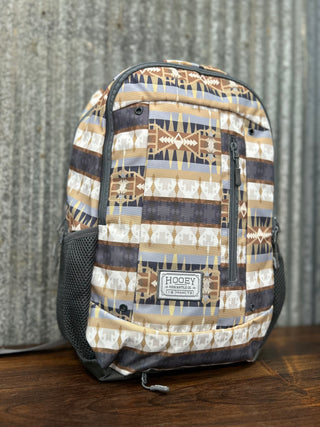 Backpack with geometric pattern on a wooden surface and textured background
