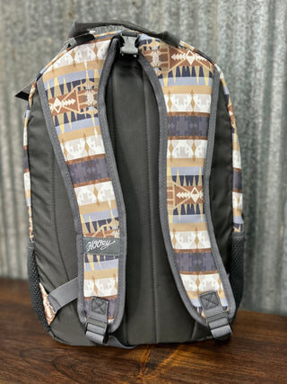 Backpack with patterned straps on a wooden surface