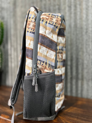 Backpack with patterned exterior and visible brand logo on a wooden surface.