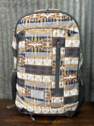 Backpack with tribal pattern on a wooden surface and metal background