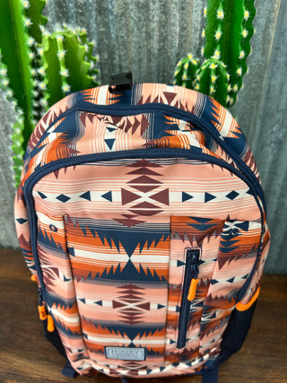 Backpack with a geometric pattern next to a cactus plant