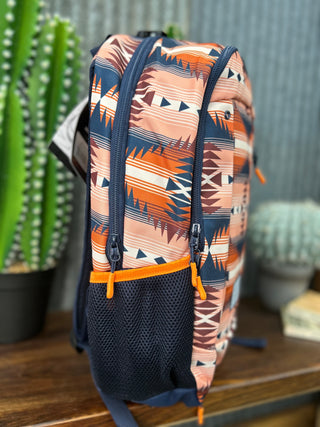 Backpack with a geometric pattern on a wooden surface with cacti in the background