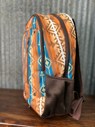 Backpack with tribal pattern on a wooden surface and metal background