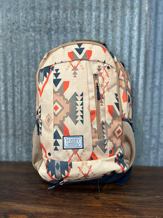 Backpack with geometric pattern on a wooden surface and textured wall background