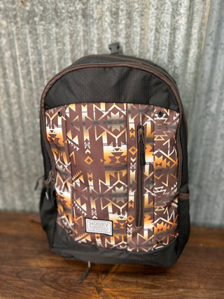 Backpack with a patterned front panel on a wooden surface and gray background