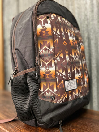 Backpack with a patterned side panel on a wooden surface