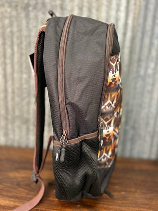 Black backpack with camouflage pattern on a wooden surface and metal wall background