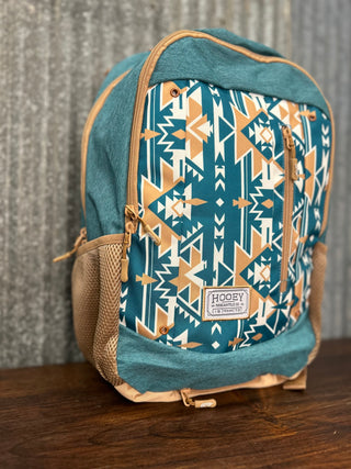 Backpack with blue and beige tribal pattern on a wooden surface