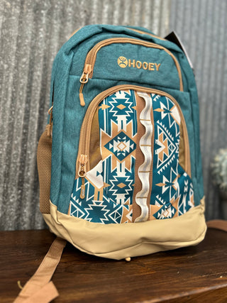 Blue and beige backpack with tribal pattern on a wooden surface