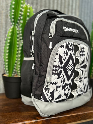 Black and white patterned backpack with 'Hooyee' branding on a wooden surface with a cactus in the background.