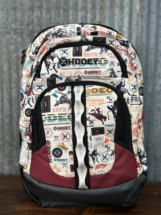 Backpack with a patterned design on a wooden surface and gray background