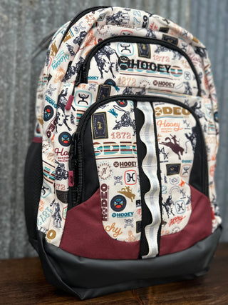 Backpack with various logos and patterns on a wooden surface
